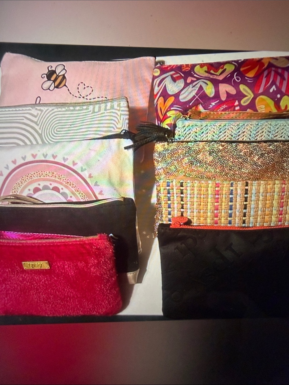 Stuffed assorted women’s cosmetic pouch. You get 1.  New